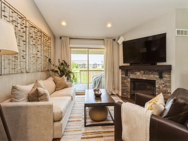 1102 NE 15th Ln, Ankeny, IA 50021 - living room featuring lofted ceiling, wood finished floors, a fireplace, and recessed lighting