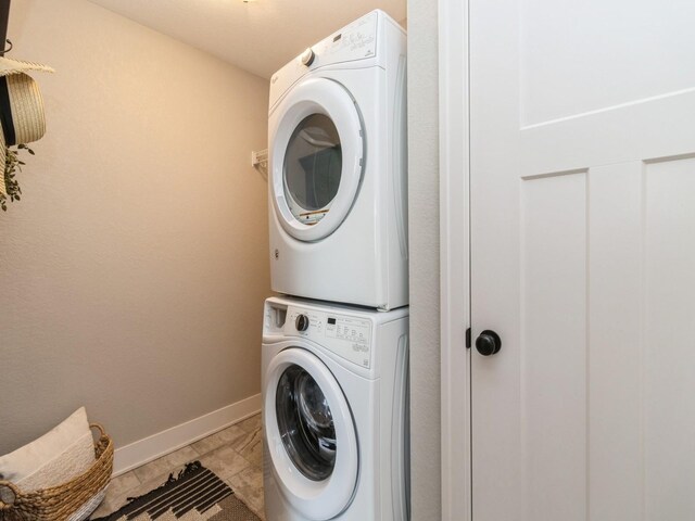 1102 NE 15th Ln, Ankeny, IA 50021 - washroom featuring stacked washer / dryer and baseboards