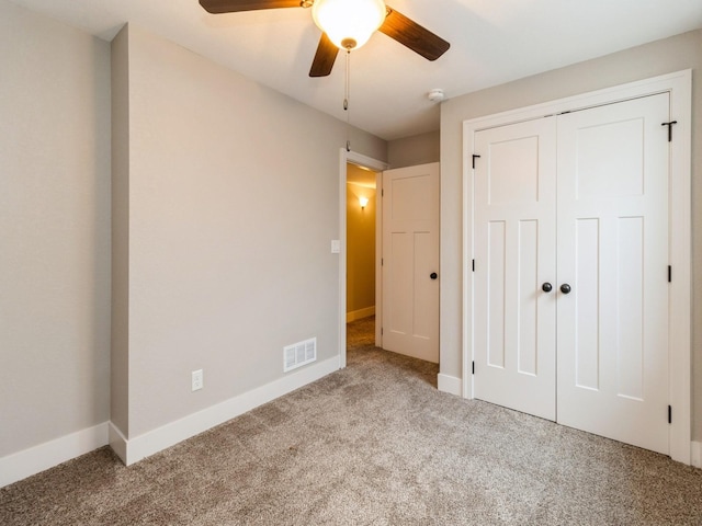 1102 NE 15th Ln, Ankeny, IA 50021 - unfurnished bedroom with carpet, a closet, and a ceiling fan
