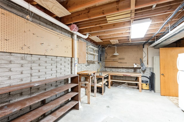 4922 Cedar Dr, West Des Moines, IA 50266 - unfinished below grade area with a workshop area, electric panel, and freestanding refrigerator
