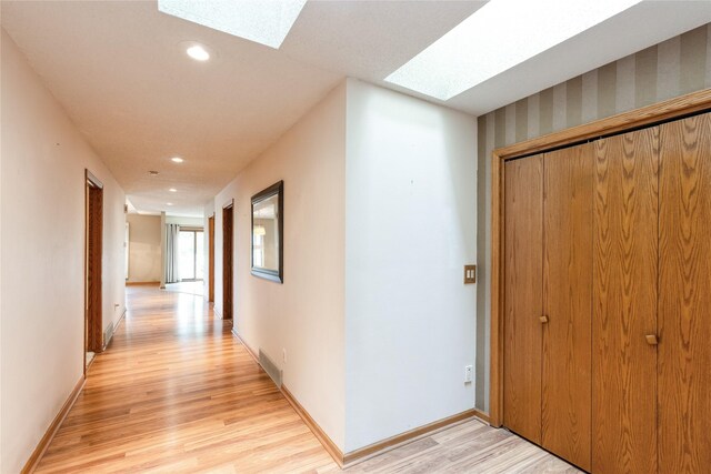 4922 Cedar Dr, West Des Moines, IA 50266 - corridor featuring a skylight, light wood-type flooring, and recessed lighting