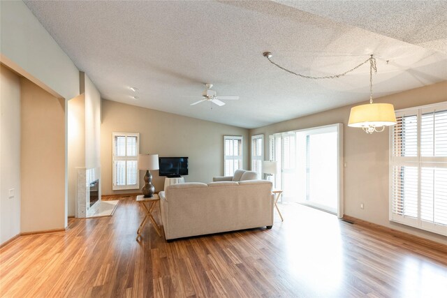 4922 Cedar Dr, West Des Moines, IA 50266 - living area with wood finished floors, a textured ceiling, plenty of natural light, and lofted ceiling