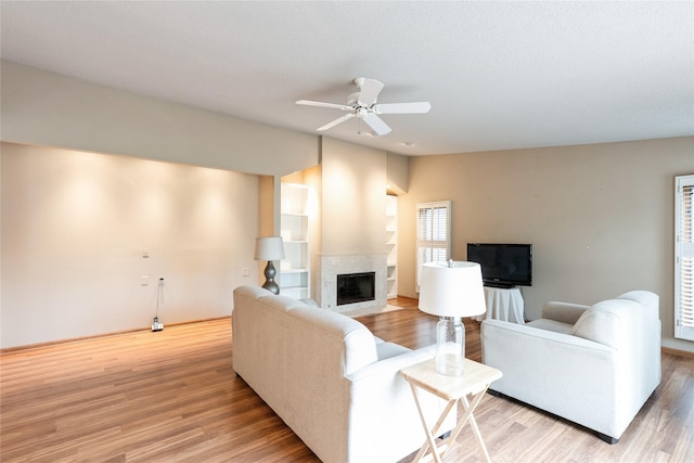 4922 Cedar Dr, West Des Moines, IA 50266 - living area with light wood-type flooring, a high end fireplace, and a ceiling fan