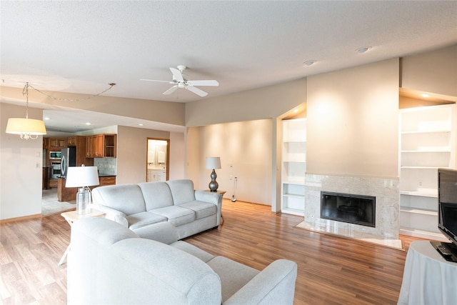 4922 Cedar Dr, West Des Moines, IA 50266 - living area featuring a ceiling fan, light wood-type flooring, a fireplace, recessed lighting, and built in features