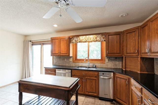 4922 Cedar Dr, West Des Moines, IA 50266 - kitchen with dishwasher, brown cabinetry, a textured ceiling, backsplash, and dark countertops