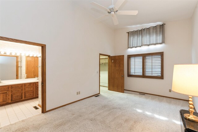 4922 Cedar Dr, West Des Moines, IA 50266 - unfurnished bedroom featuring high vaulted ceiling, light carpet, ensuite bathroom, and a ceiling fan