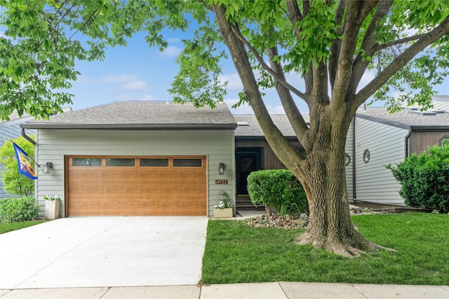 4922 Cedar Dr, West Des Moines, IA 50266 - view of front facade featuring an attached garage, driveway, a front lawn, and roof with shingles