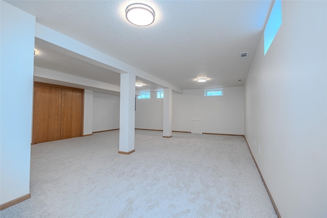 609 17th St, West Des Moines, IA 50265 - below grade area featuring light carpet and baseboards