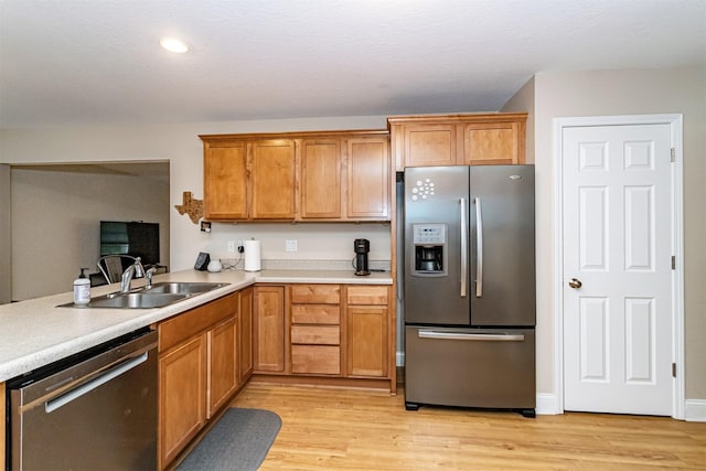 2732 Northridge Ln, Ames, IA 50010 - kitchen with stainless steel appliances, light wood finished floors, light countertops, brown cabinetry, and recessed lighting