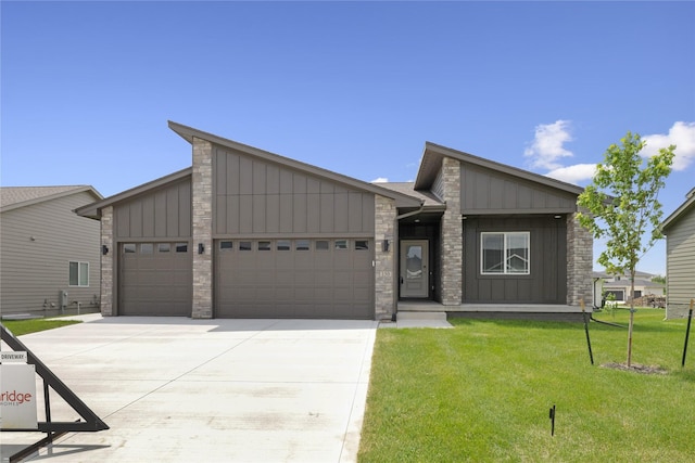 150 NW Hidden Knl, Waukee, IA 50263 - mid-century modern home featuring board and batten siding, an attached garage, driveway, a front lawn, and stone siding