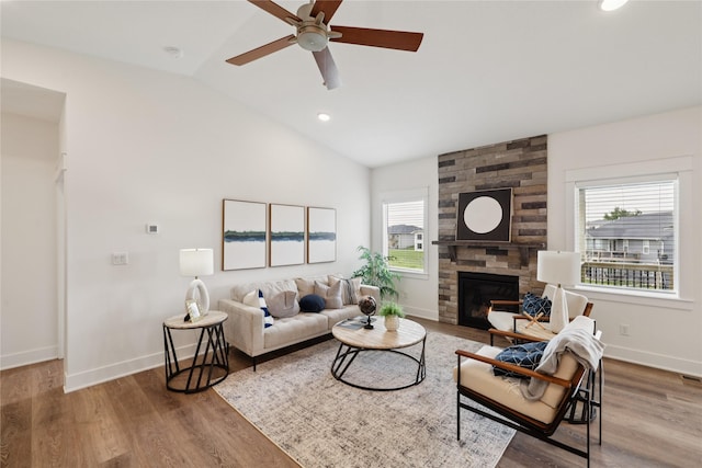 150 NW Hidden Knl, Waukee, IA 50263 - living room featuring vaulted ceiling, a ceiling fan, a stone fireplace, wood finished floors, and recessed lighting
