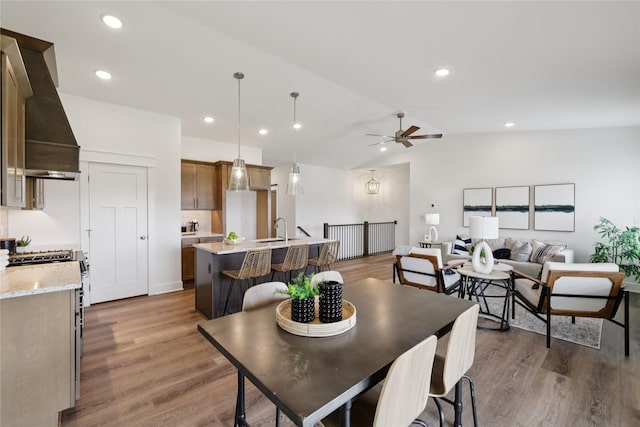 150 NW Hidden Knl, Waukee, IA 50263 - dining space featuring ceiling fan, vaulted ceiling, wood finished floors, and recessed lighting
