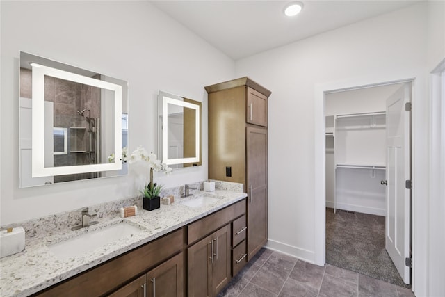 150 NW Hidden Knl, Waukee, IA 50263 - full bathroom featuring double vanity, a spacious closet, and a tile shower