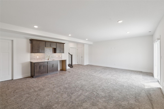 150 NW Hidden Knl, Waukee, IA 50263 - unfurnished living room with bar with sink, light carpet, and recessed lighting
