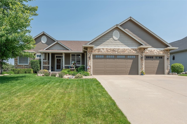 6725 NW 93rd St, Johnston, IA 50131 - view of front of home with a garage, stone siding, a front lawn, and driveway