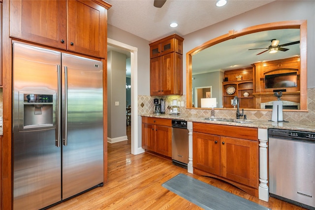 6725 NW 93rd St, Johnston, IA 50131 - kitchen featuring stainless steel appliances, ceiling fan, brown cabinetry, and recessed lighting