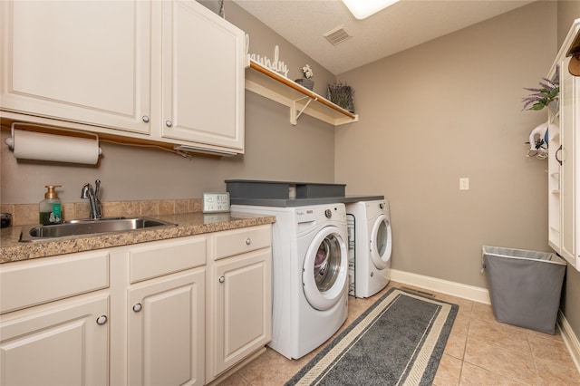 6725 NW 93rd St, Johnston, IA 50131 - laundry area with washing machine and clothes dryer, cabinet space, and light tile patterned floors