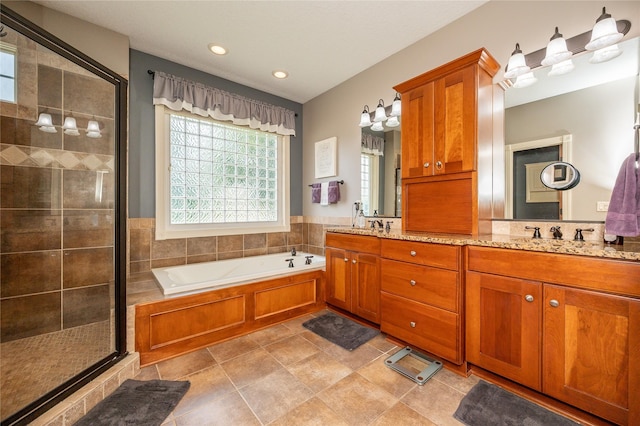6725 NW 93rd St, Johnston, IA 50131 - full bathroom with a shower stall, a garden tub, double vanity, and recessed lighting