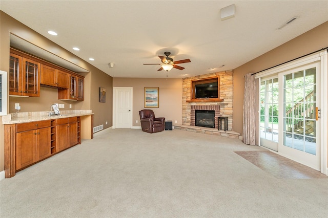 6725 NW 93rd St, Johnston, IA 50131 - living area with light carpet, a fireplace, ceiling fan, and recessed lighting
