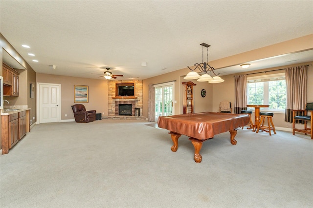 6725 NW 93rd St, Johnston, IA 50131 - rec room with a fireplace, a ceiling fan, billiards table, light carpet, and healthy amount of natural light