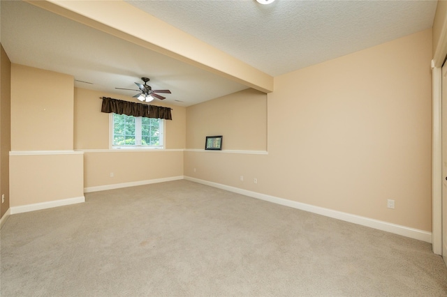 6725 NW 93rd St, Johnston, IA 50131 - spare room featuring light carpet, ceiling fan, beam ceiling, and a textured ceiling