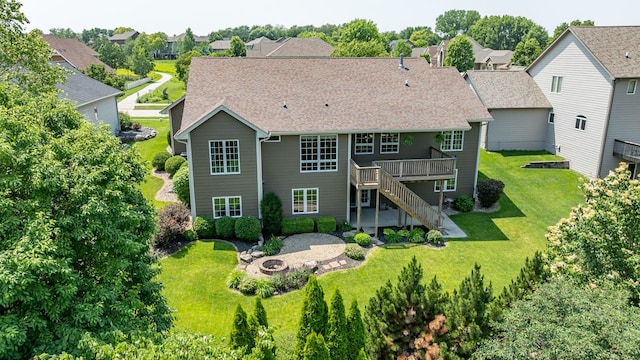 6725 NW 93rd St, Johnston, IA 50131 - rear view of property featuring an outdoor fire pit, a lawn, stairs, a wooden deck, and a shingled roof