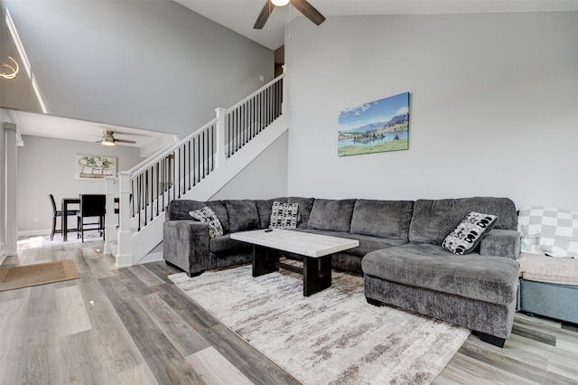5462 Longview Ct Unit 1, Johnston, IA 50131 - living area with ceiling fan, wood finished floors, stairway, and high vaulted ceiling