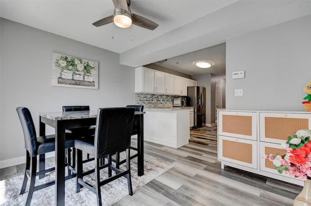 5462 Longview Ct Unit 1, Johnston, IA 50131 - dining room featuring ceiling fan and light wood-style flooring