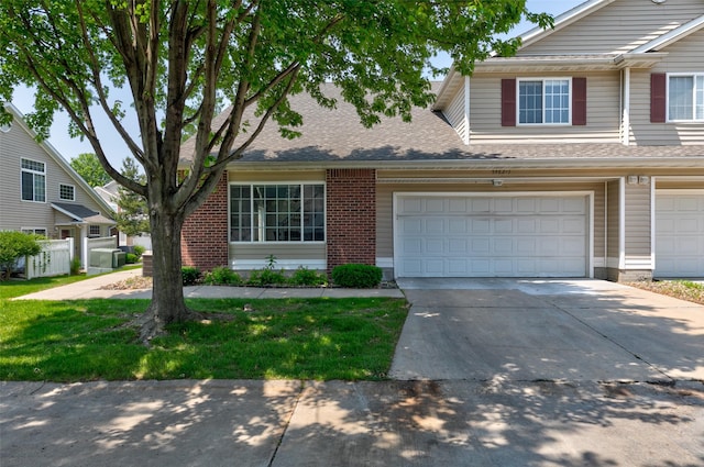 5462 Longview Ct Unit 1, Johnston, IA 50131 - view of front of home featuring brick siding, driveway, roof with shingles, and a front lawn