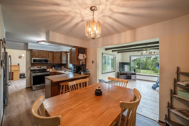 1543 S 16th Ave W, Newton, IA 50208 - dining room featuring wood finished floors and a chandelier