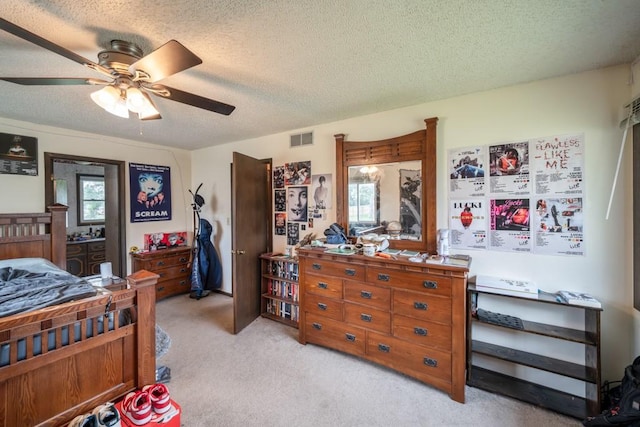 1543 S 16th Ave W, Newton, IA 50208 - bedroom featuring light carpet, multiple windows, a textured ceiling, and a ceiling fan