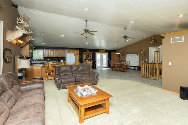 2626 SE 72nd St, Runnells, IA 50237 - living room featuring light carpet, a ceiling fan, and vaulted ceiling