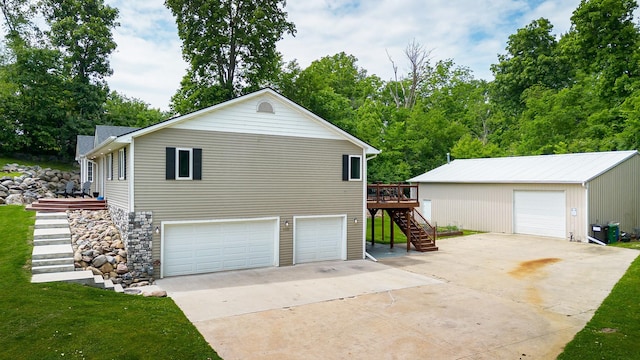 2626 SE 72nd St, Runnells, IA 50237 - view of property exterior featuring stairway, a deck, a detached garage, and a lawn