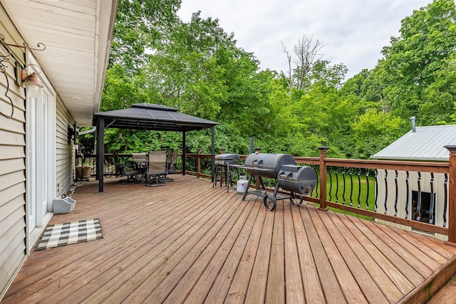 2626 SE 72nd St, Runnells, IA 50237 - wooden deck with outdoor dining space, a gazebo, area for grilling, and view of wooded area
