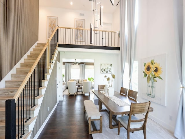 1010 Frederick Ave, Des Moines, IA 50315 - dining area featuring a high ceiling, stairway, and wood finished floors