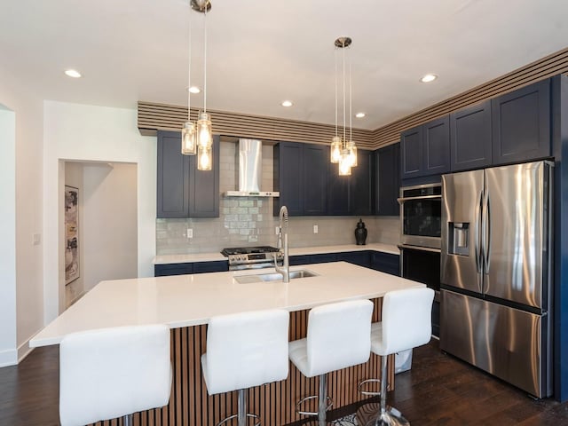 1010 Frederick Ave, Des Moines, IA 50315 - kitchen featuring appliances with stainless steel finishes, wall chimney exhaust hood, dark wood finished floors, backsplash, and recessed lighting