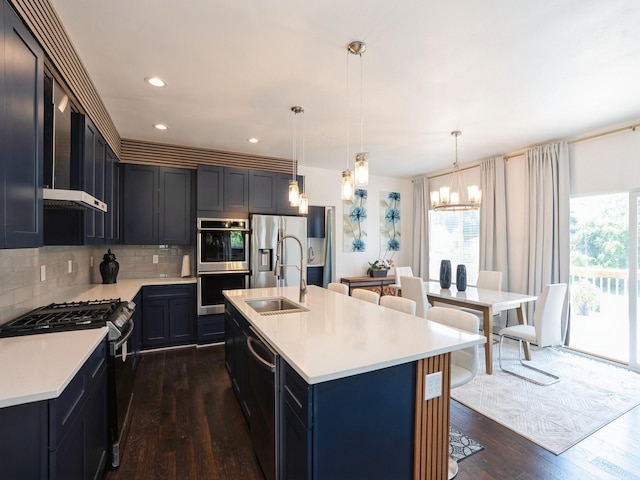 1010 Frederick Ave, Des Moines, IA 50315 - kitchen featuring stainless steel appliances, a chandelier, dark wood-type flooring, light countertops, and decorative backsplash