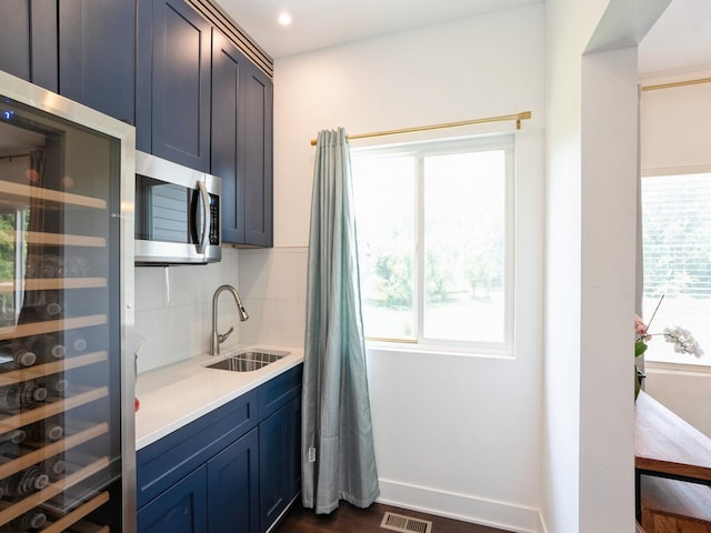 1010 Frederick Ave, Des Moines, IA 50315 - kitchen featuring stainless steel microwave, plenty of natural light, beverage cooler, and recessed lighting