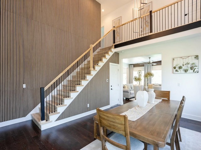 1010 Frederick Ave, Des Moines, IA 50315 - dining space with stairway, wood finished floors, a ceiling fan, and a towering ceiling