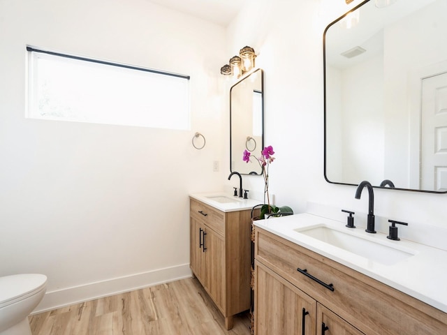 1010 Frederick Ave, Des Moines, IA 50315 - bathroom with two vanities and wood finished floors