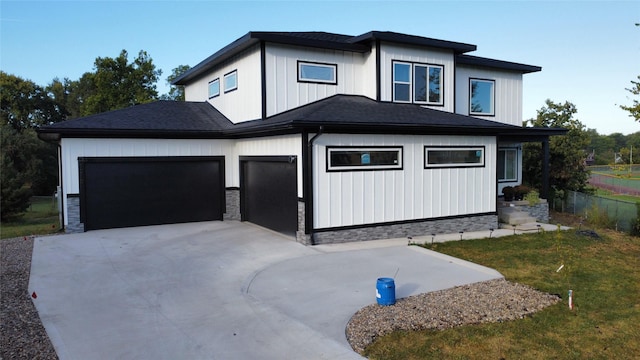 1010 Frederick Ave, Des Moines, IA 50315 - view of front of house with a garage, driveway, and board and batten siding