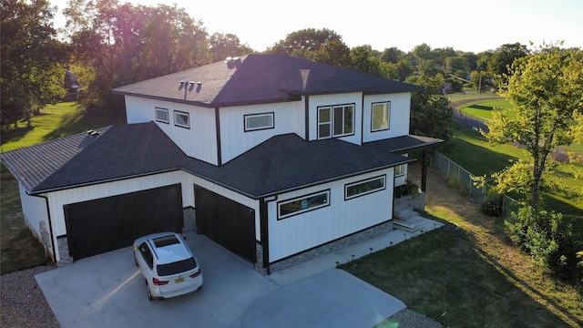 1010 Frederick Ave, Des Moines, IA 50315 - rear view of house with a shingled roof, driveway, and stone siding