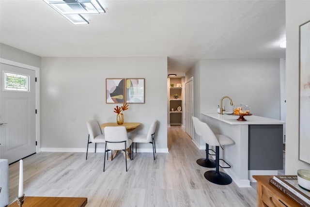 4127 E Seneca Ave, Des Moines, IA 50317 - dining space featuring light wood-style flooring and baseboards