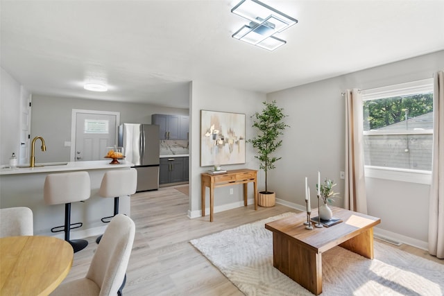 4127 E Seneca Ave, Des Moines, IA 50317 - living room with light wood-type flooring and baseboards