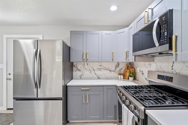 4127 E Seneca Ave, Des Moines, IA 50317 - kitchen featuring appliances with stainless steel finishes, gray cabinets, light countertops, backsplash, and recessed lighting