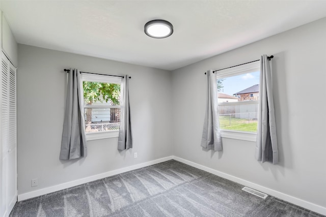 4127 E Seneca Ave, Des Moines, IA 50317 - empty room with healthy amount of natural light and carpet