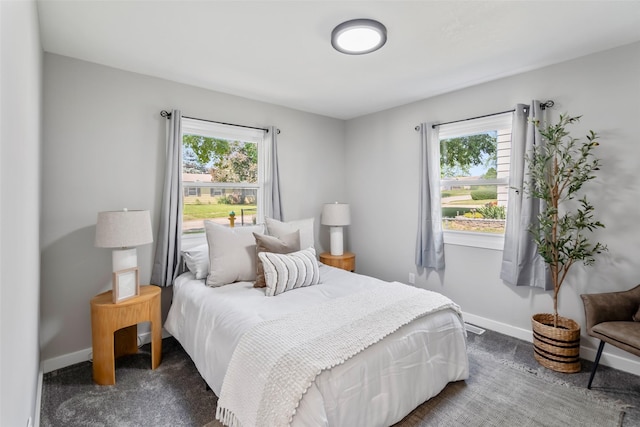 4127 E Seneca Ave, Des Moines, IA 50317 - bedroom with dark colored carpet and multiple windows