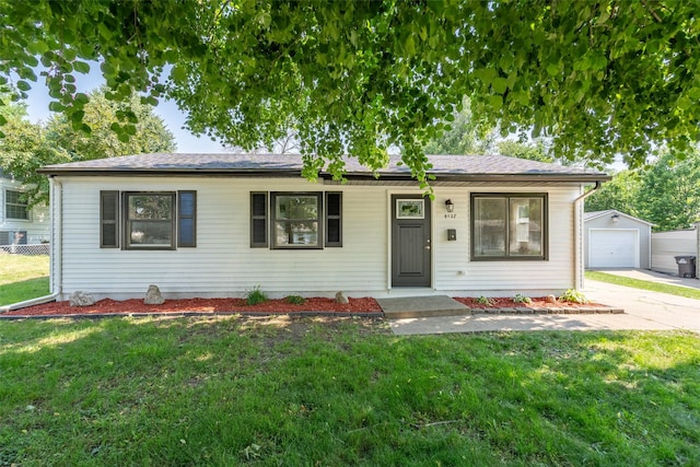 4127 E Seneca Ave, Des Moines, IA 50317 - view of front of house featuring an outdoor structure, concrete driveway, a front lawn, and a detached garage