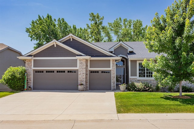 9180 Geanna Ct, West Des Moines, IA 50266 - view of front of house featuring a garage, concrete driveway, a front yard, and stone siding