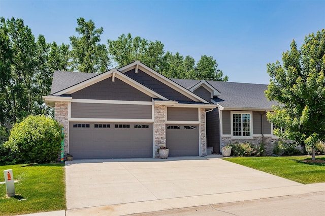 9180 Geanna Ct, West Des Moines, IA 50266 - craftsman-style home with a garage, stone siding, concrete driveway, a front yard, and a shingled roof